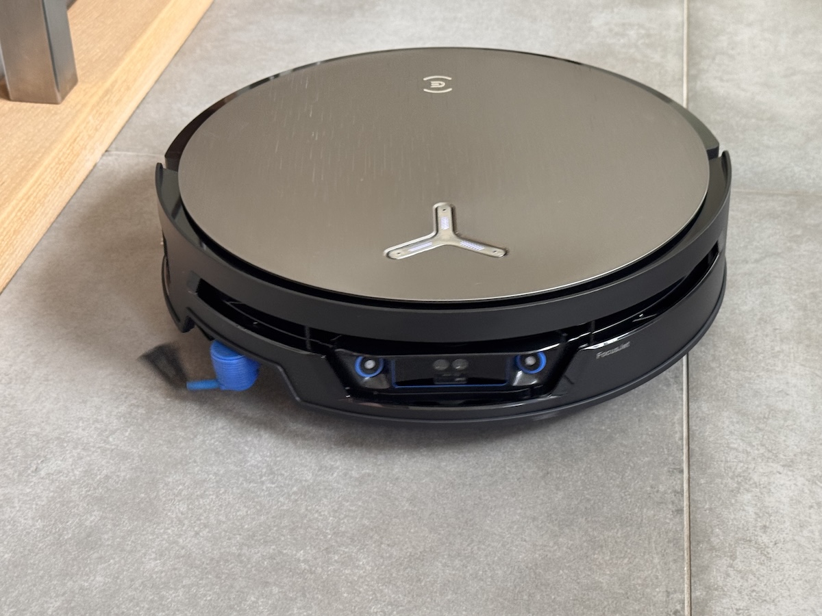 Ecovacs Deebot X12S OmniCyclone auf Fliesenboden, Frontansicht mit der FocusJet-Sensoreinheit und dem gebürsteten Metalldeckel