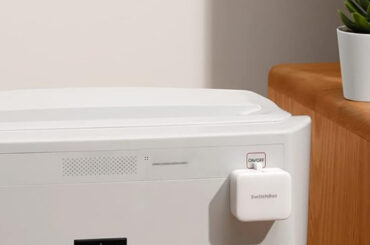 Switchbot smarter Schalter, angebracht an einer Waschmaschine