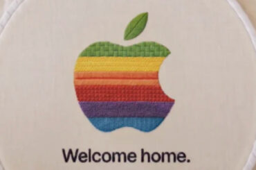 Apple-Teaser „Welcome home“: Regenbogen-Apfel-Logo, auf einen Stickrahmen gestickt